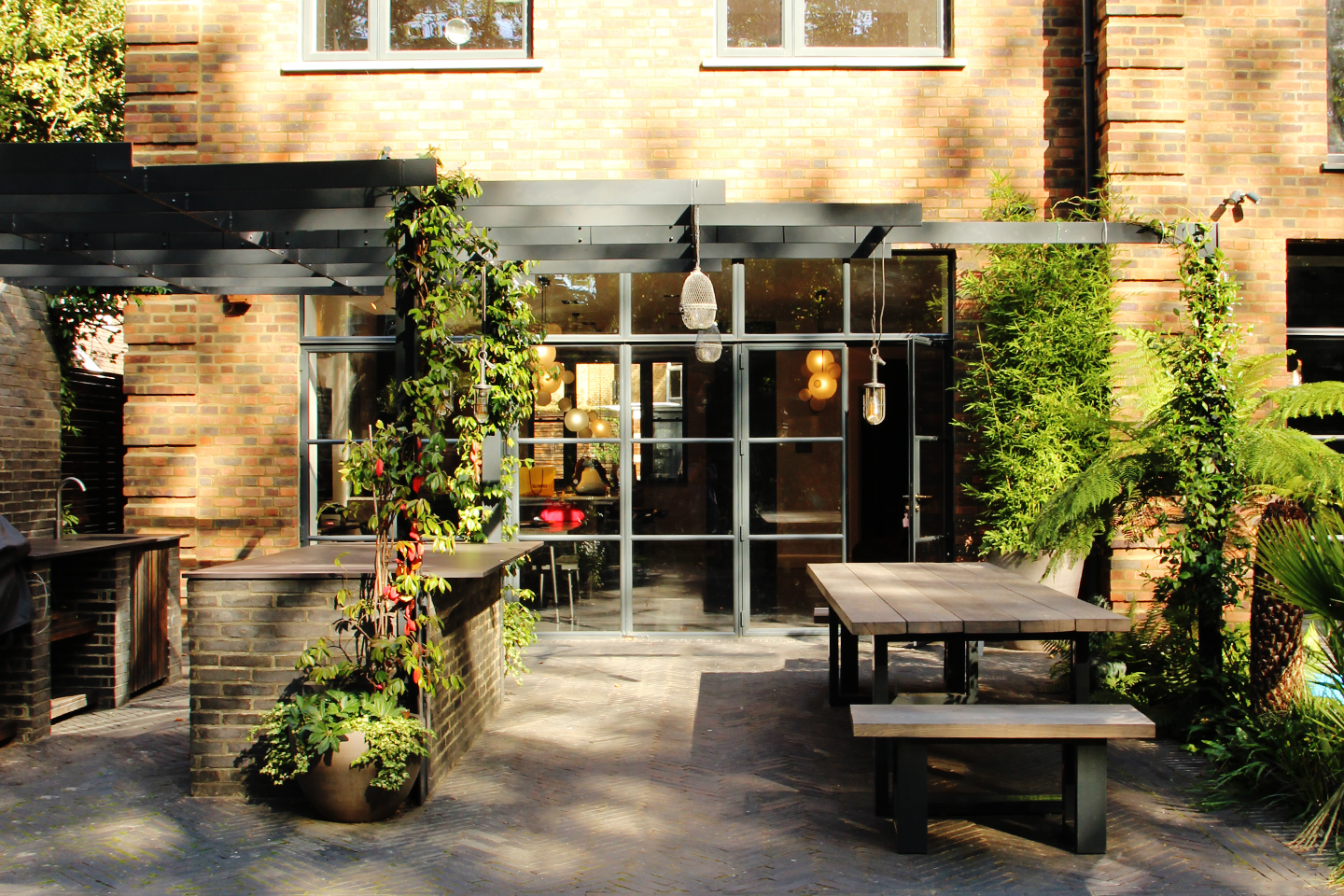 Garden terrace with outdoor kitchen and dining at Lancaster Grove